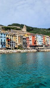 Sparkling turquoise water along the coastline with colorful homes and businesses
