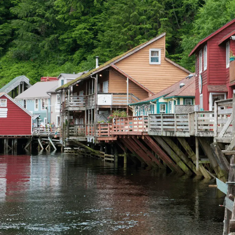 Historic wooden buildings built on pilings over the water at Creek Street in Ketchikan, Alaska.
