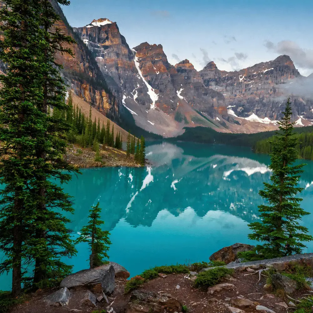 Turquoise glacier water of Moraine Lake reflecting the Valley of the Ten Peaks in Banff National Park, Canada.