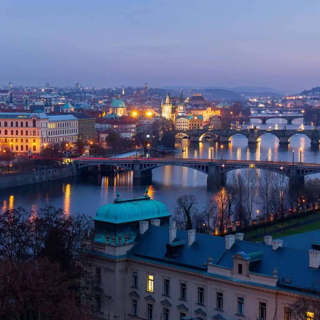A beautiful evening skyline view of the historic spires and rooftops in Prague, Czech Republic