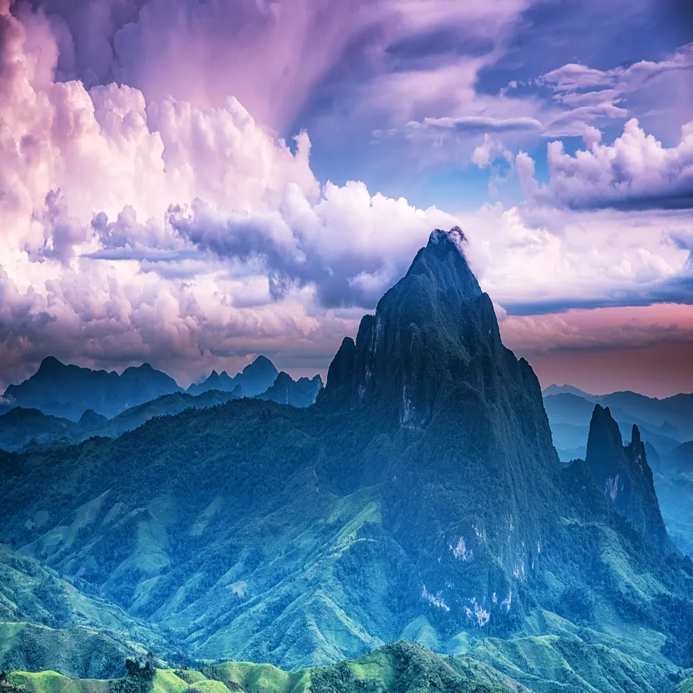 Breathtaking scenery featuring majestic, rugged mountain peaks rising into a clear sky, highlighting the rugged beauty of nature.