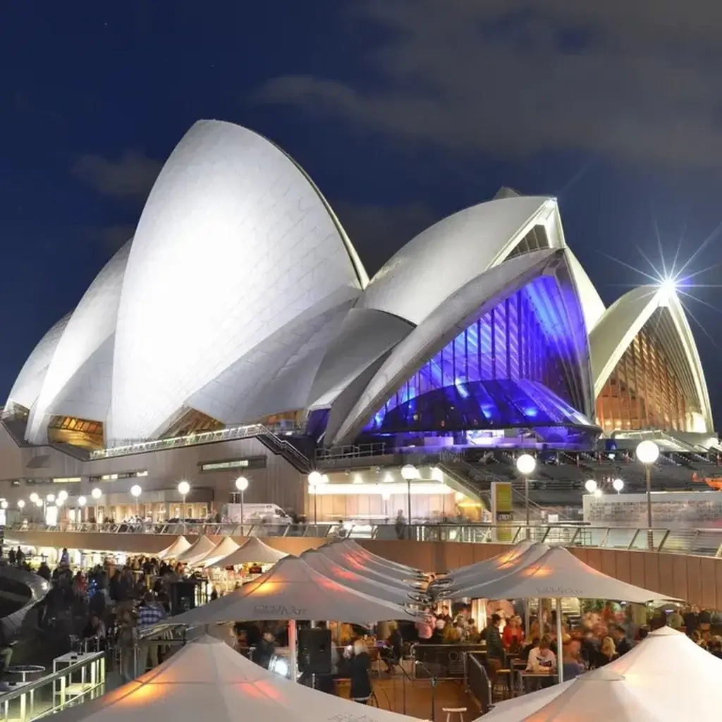 The iconic white sails of the Sydney Opera House along the waterfront in Australia
